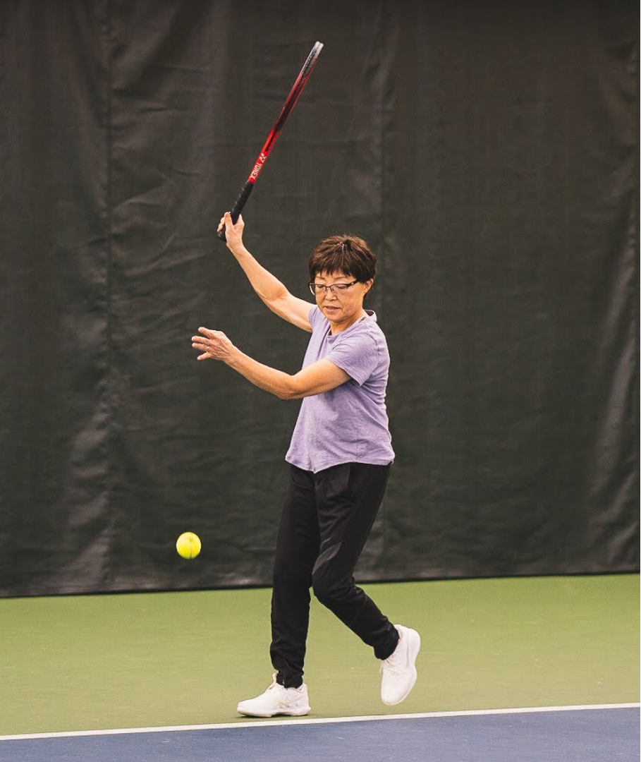 Mia's mom playing competitive tennis
